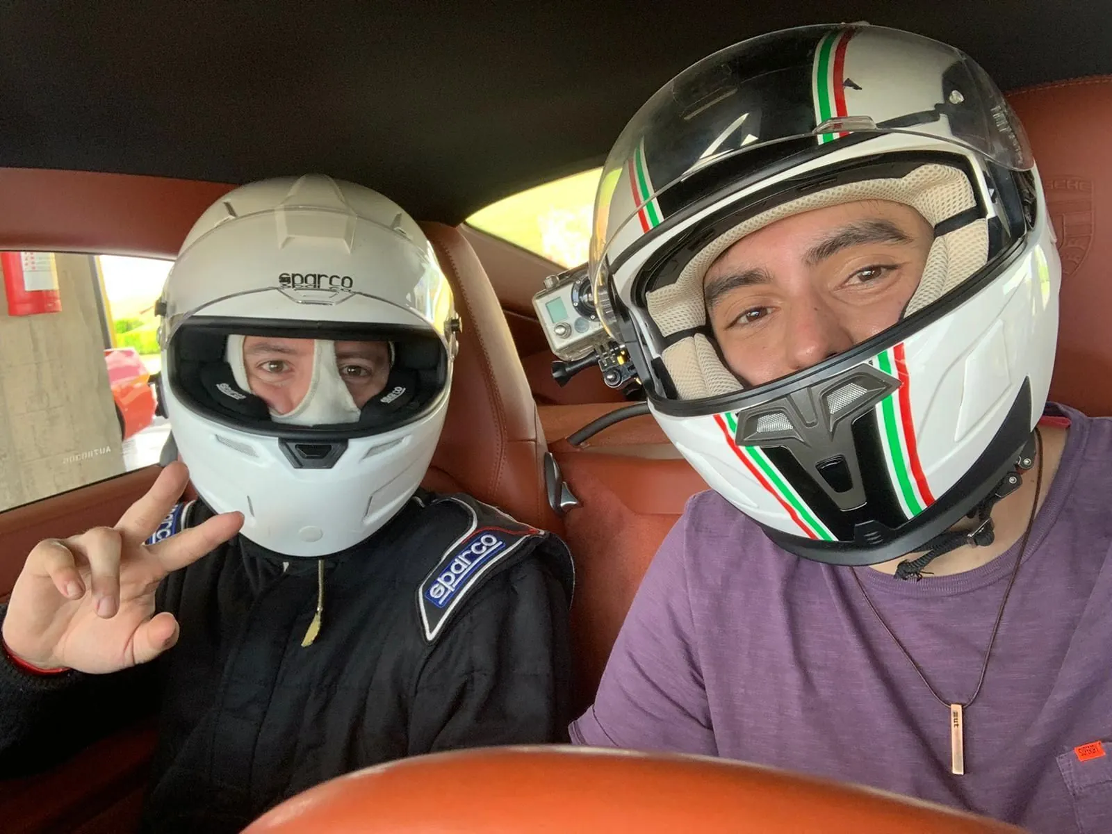 Aluno e instrutor de capacete dentro do carro antes de entrar na pista